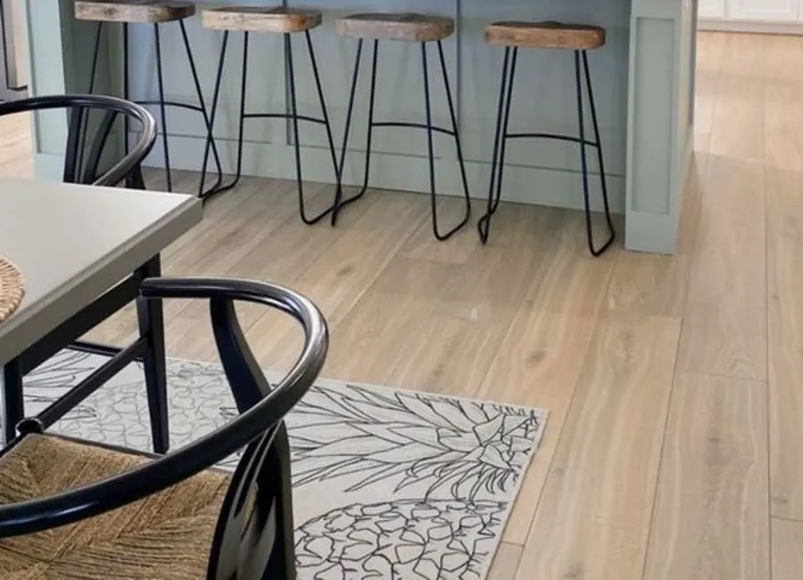 Open-concept great room with wood flooring